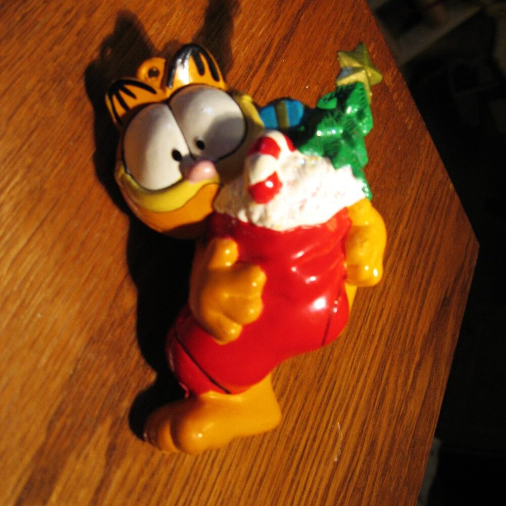 Garfield holding red fireplace sock with gifts in it Christmas Ornament